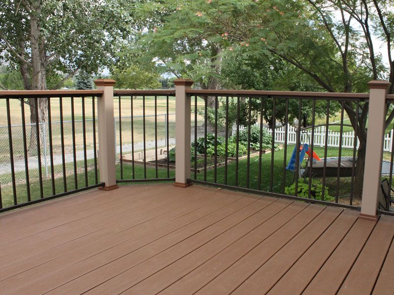 Iron w/composite post & 2x4 cap rail - CFC Fences & Decks