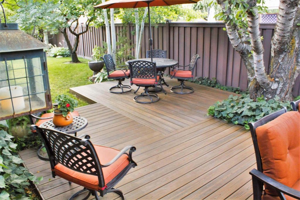 Professional deck builders installing custom composite deck in Orem backyard.