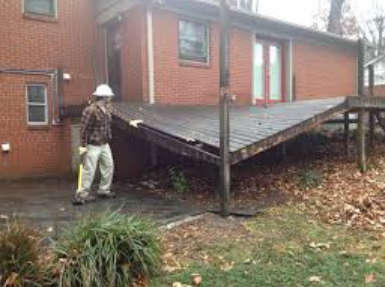 Professional deck builders installing custom composite deck in Orem backyard.